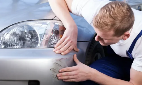man-trying-fix-scratch-on-car-198868544